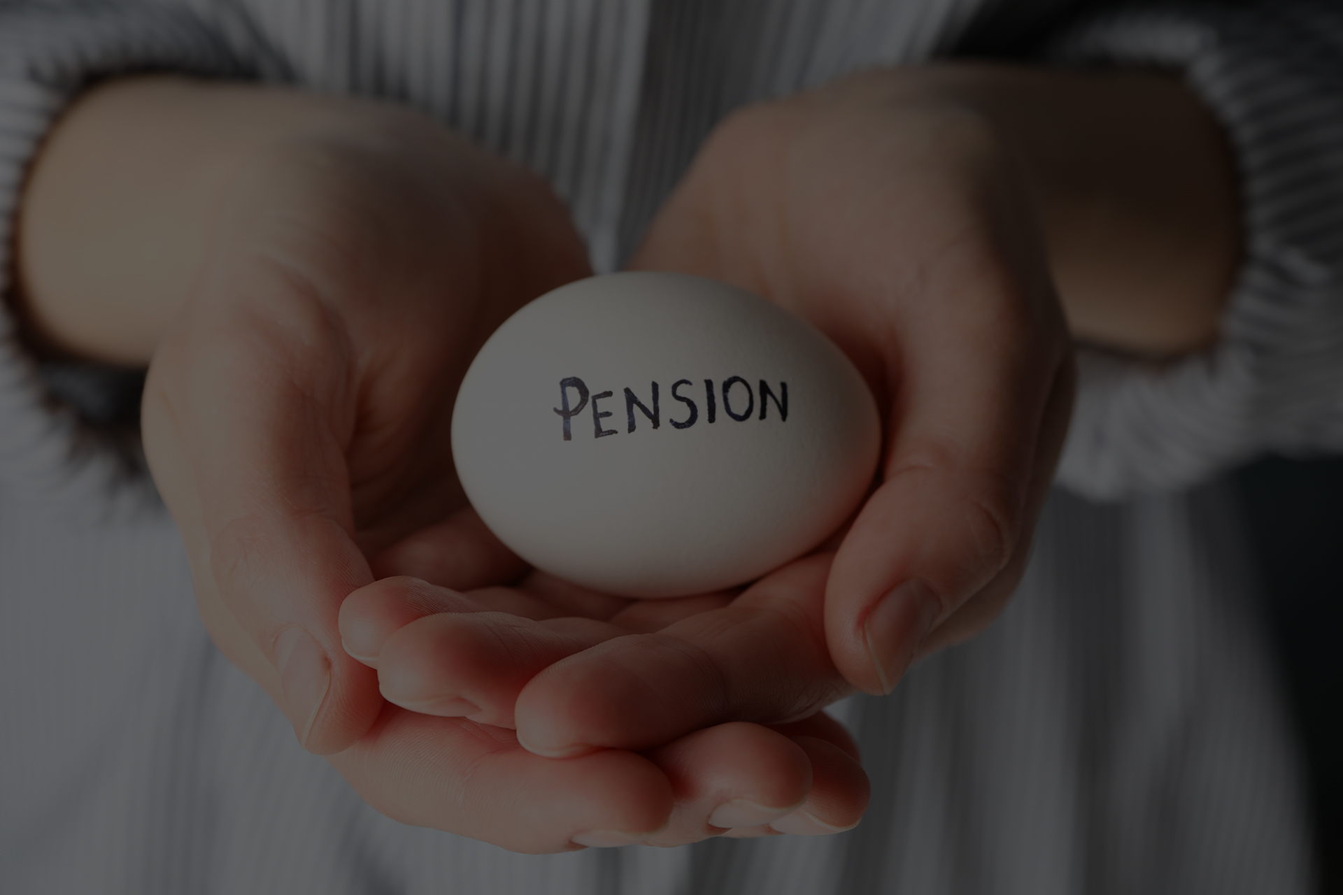 Woman holds egg with inscription Pension, close up